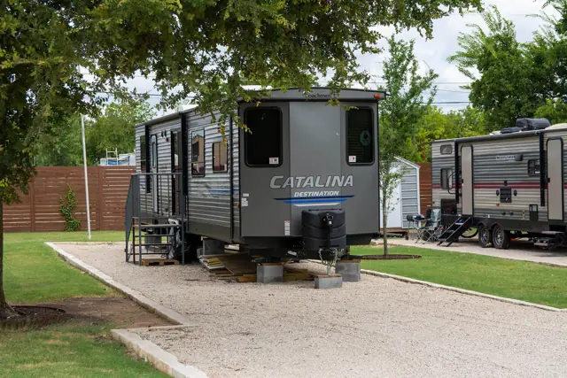 RV campsite beneath mature shade trees